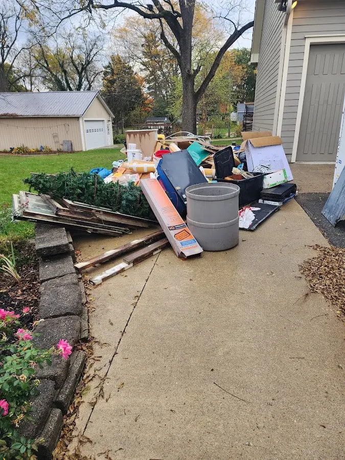 Dumpster being loaded with debris for Estate Cleanout Dumpster Rental in Combined Locks